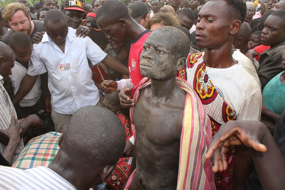 Khabeli stands stock still as the local surgeons perform the cut on him