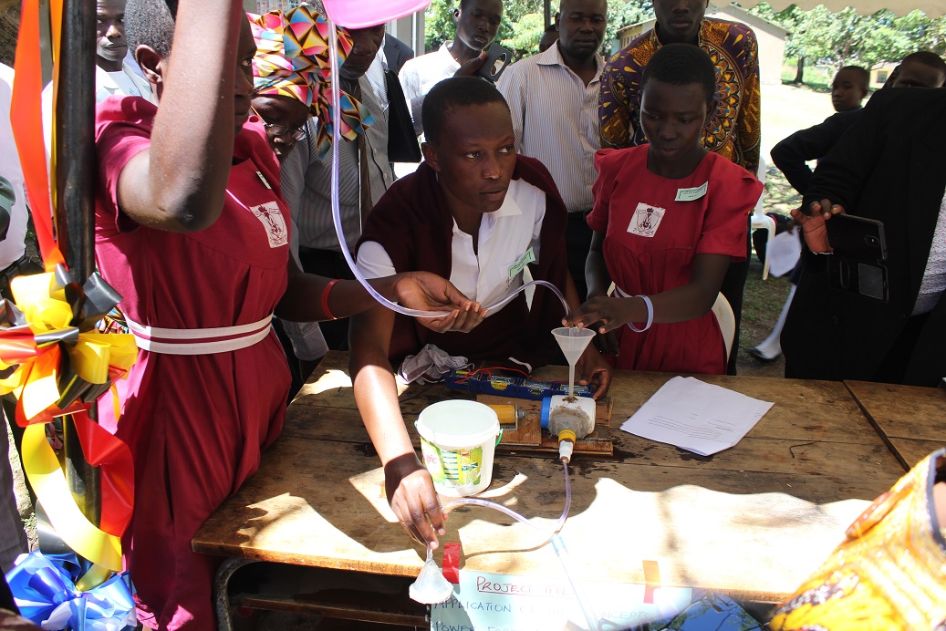 One of the participating students shows adjudicators how her prototype innovation works