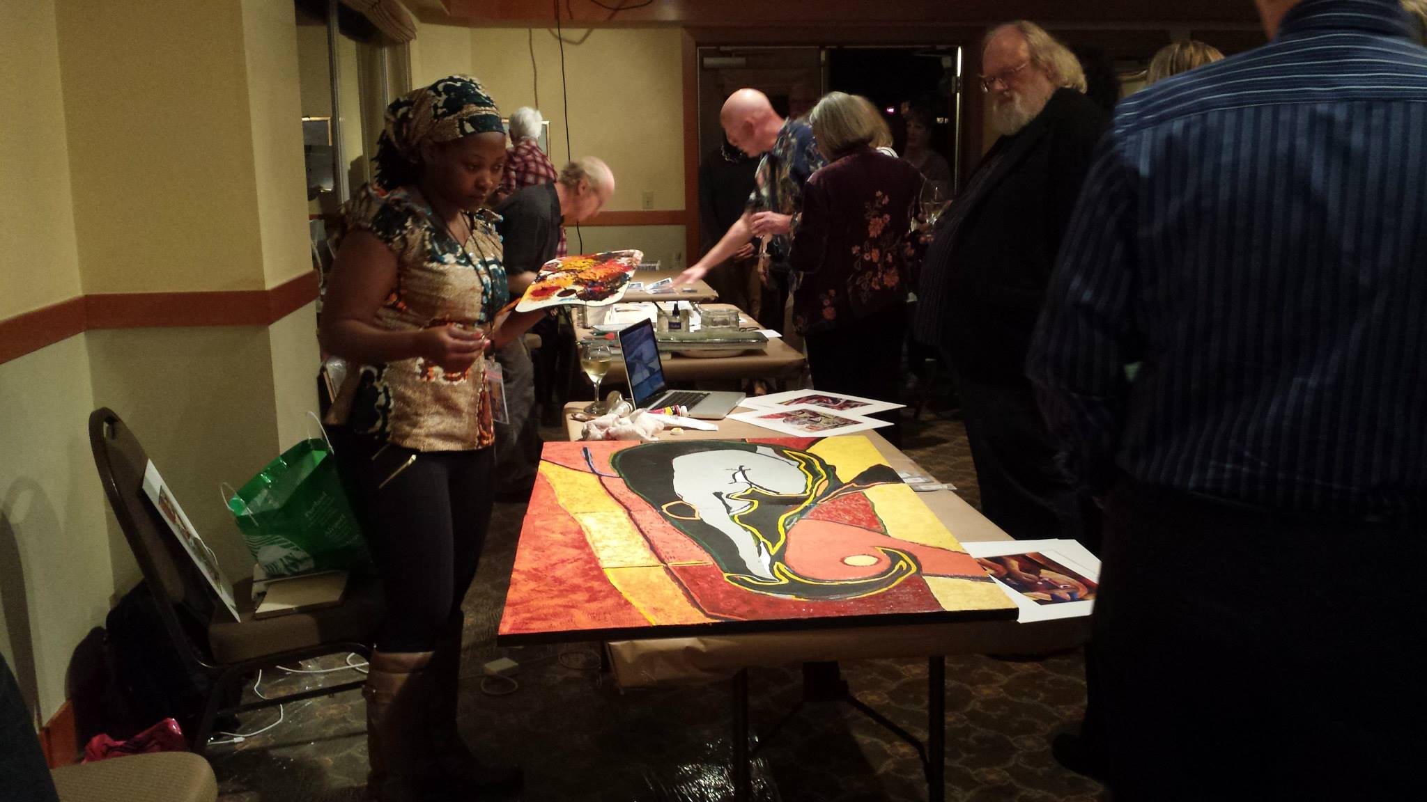 Muwonge polishing up one of her paintings